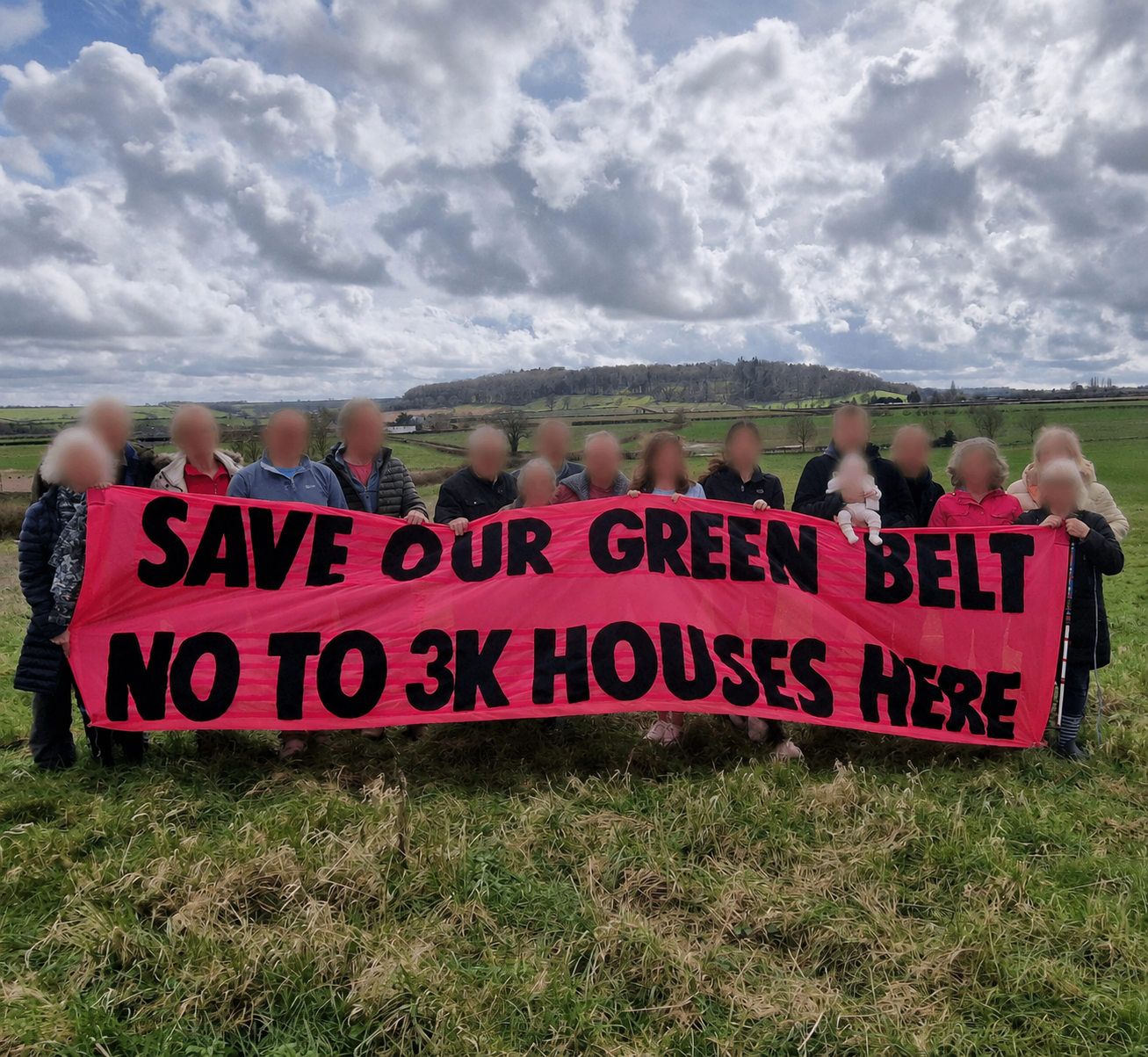 Residents holding a banner opposing green belt housing development